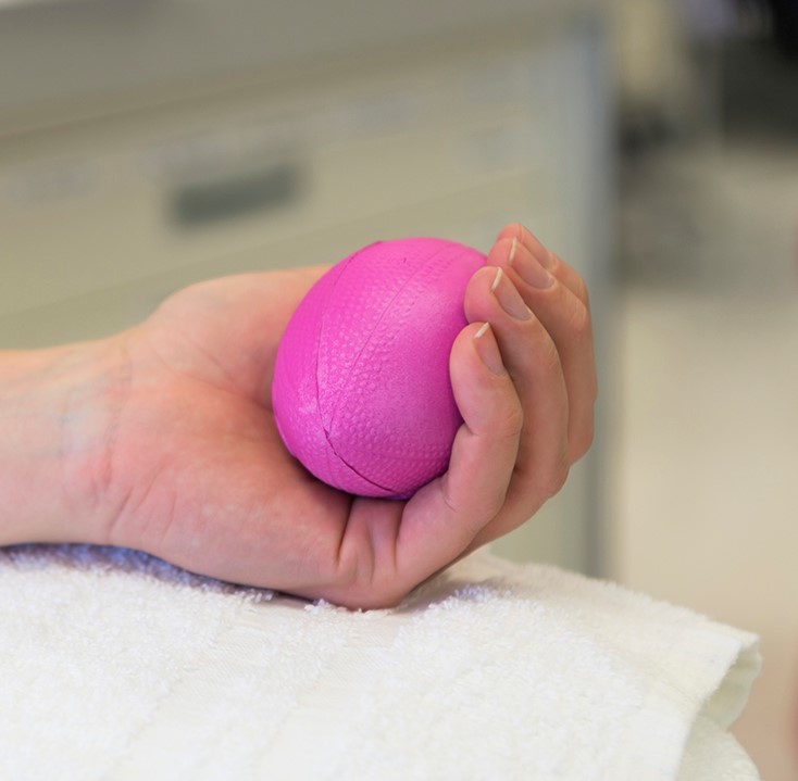 Hand holding a pink ball